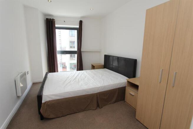 Bright bedroom with ample storage and large bed...