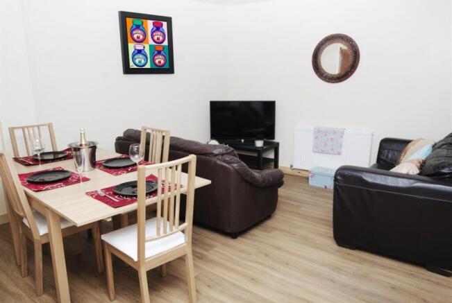 Bright, modern living and dining area with a li...