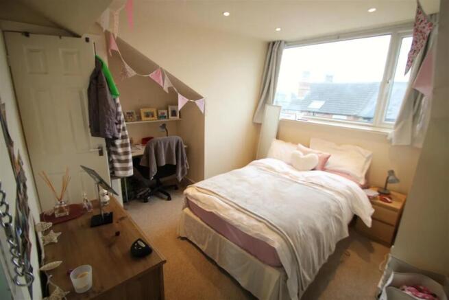 A cozy and well-lit double bedroom featuring a ...