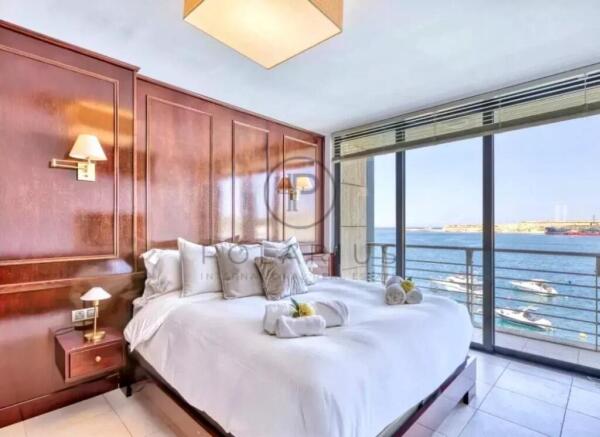 Bright and spacious bedroom with a stunning waterf