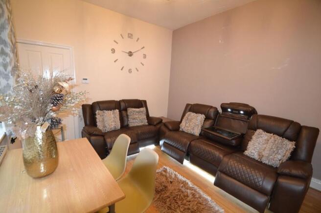 A spacious, welcoming living room featuring a l...