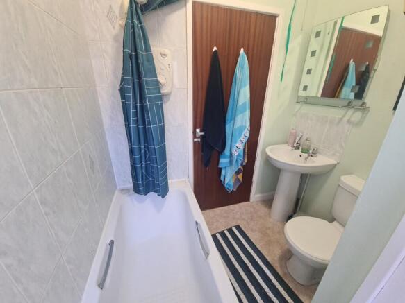 A clean and well-maintained bathroom with a bat...