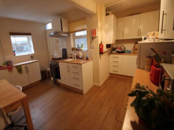 A spacious, well-lit living room with modern fu...