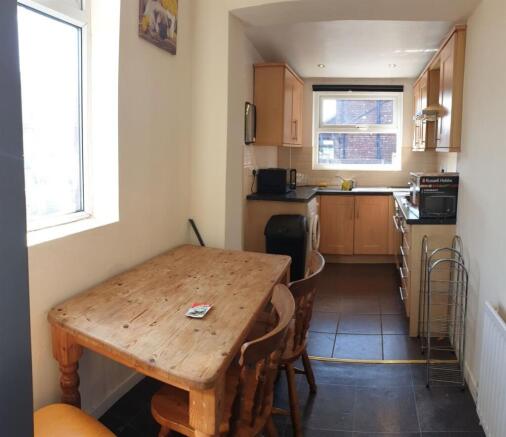 Bright galley kitchen with natural light from t...