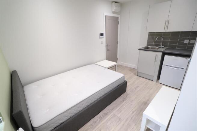 Bright, tidy studio-style bedroom with a comfor...