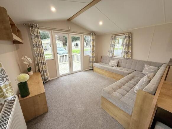 Bright Lounge With L Shaped Seating And Patio Door