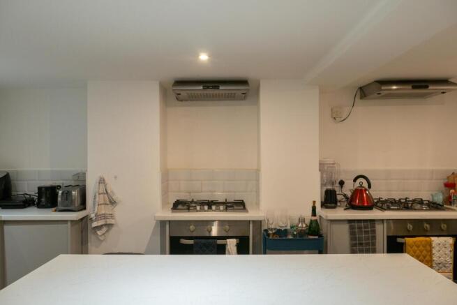 Modern kitchen area with appliances and bright ...
