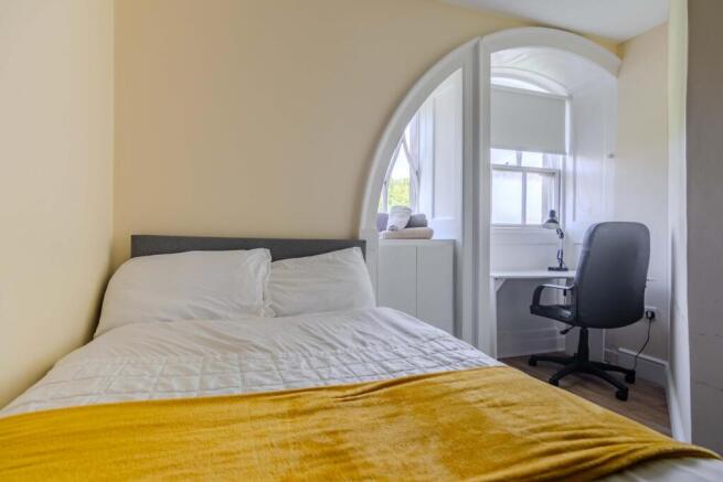 Double bedroom with desk under the arched window
