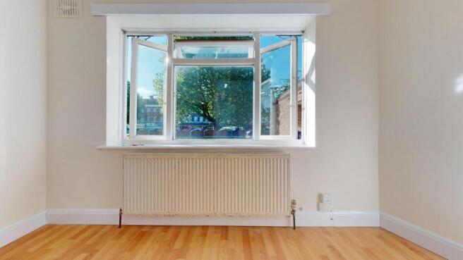 Bright, airy room with large sunlit window...
