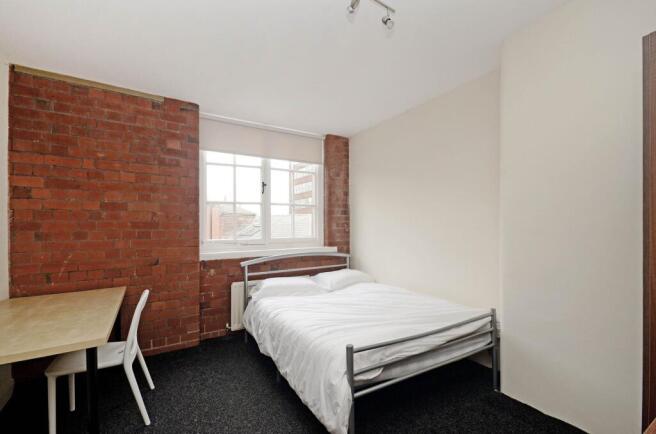 A bright and inviting double bedroom featuring ...