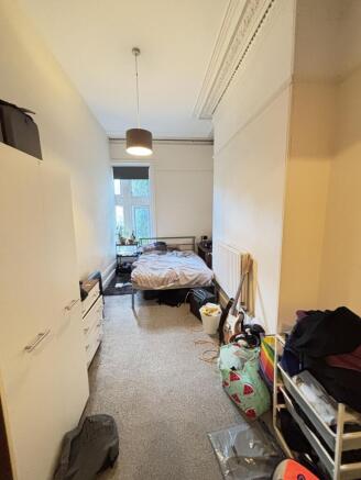A cozy bedroom with a double bed, minimal natur...