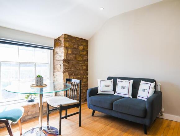 Living room with exposed stone wall