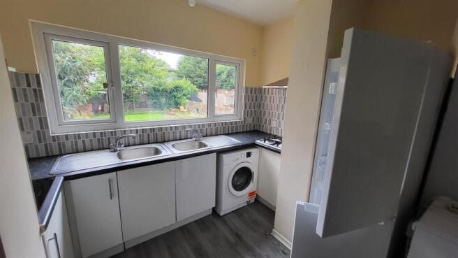 Bright, modern kitchen with a large window over...