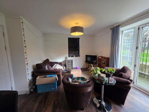 Bright, ground-floor living room with large pat...