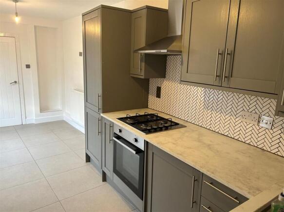 Modern kitchen with stylish cabinets and tiling...