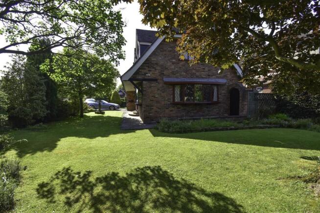 Driveway and mature landscaped gardens