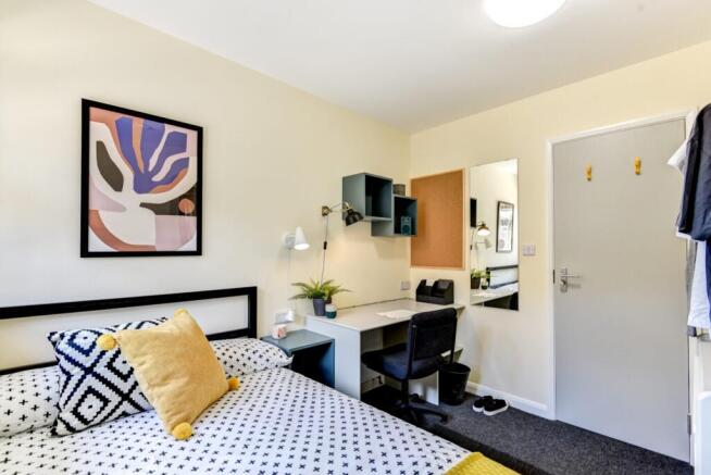 Bright bedroom with modern desk and stylish dec...