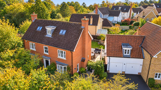 Autumn Aerial View of a Leafy Suburban Home.png