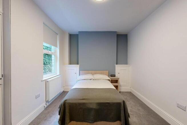 Bright and welcoming master bedroom featuring a...