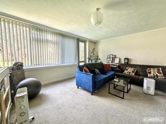 Bright lounge with large window and modern seat...