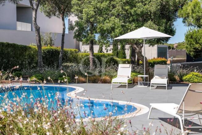 Pool terrace with sunloungers and parasol