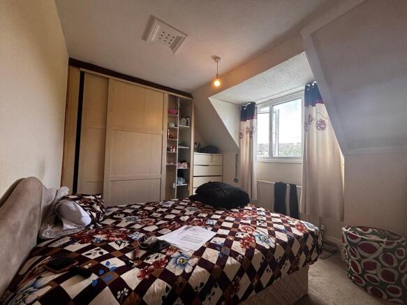 Bright bedroom with integrated storage solution...