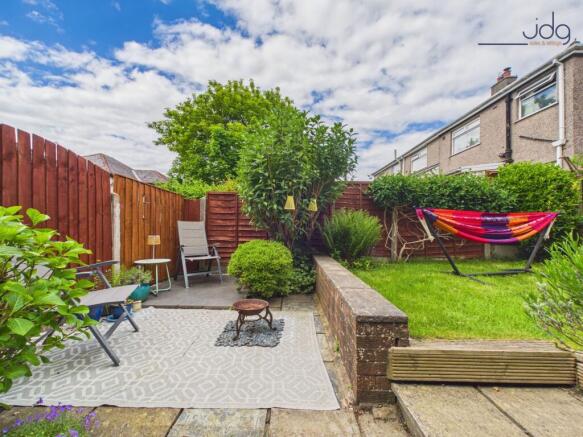 Tiered Garden with a mixture of flags, decking and lawn.