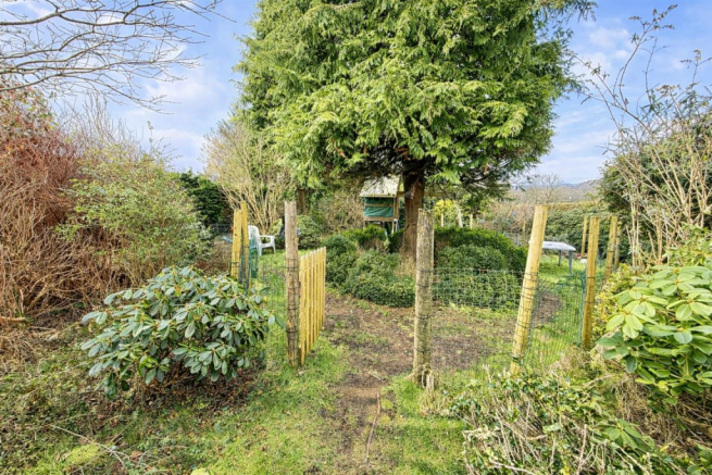 Rustic garden pathway with lush greenery.png