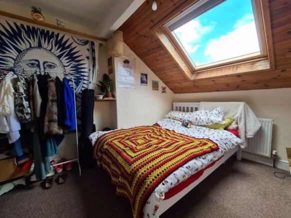 Bright and cozy double bedroom with a skylight ...