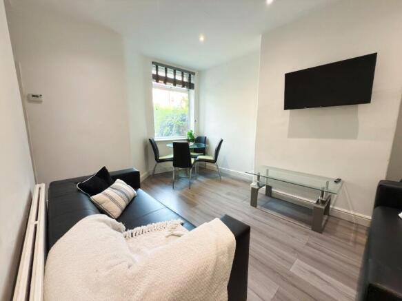 Bright, modern living room with laminate floori...