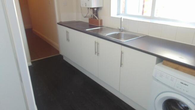 Bright kitchen with ample counter space, white ...