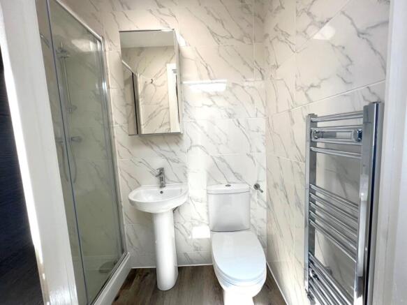 Modern bathroom with a walk-in shower, pedestal...