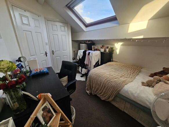 Cozy double attic bedroom with a double bed, sk...