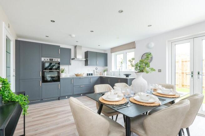 The spacious kitchen/dining area has double doors to the rear garden