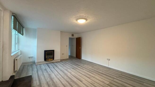 Bright and airy lounge with modern wood floorin...
