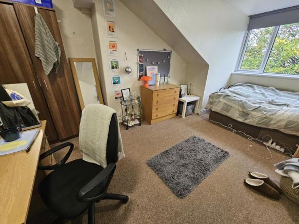 A well-kept bedroom featuring natural light fro...
