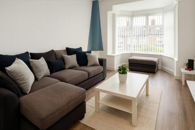 Bright, modern living room with a large comfort...