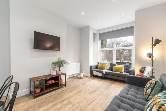 Bright modern living room with large window, co...