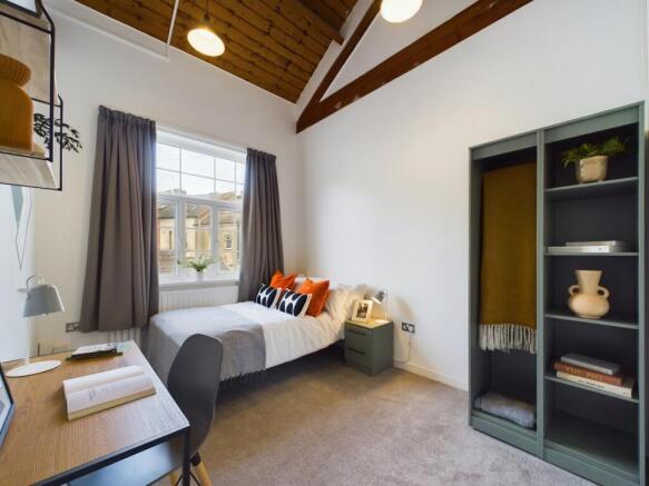 A bright and inviting double bedroom featuring ...