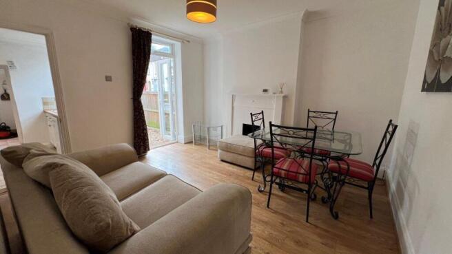 Bright living area with stylish dining set...