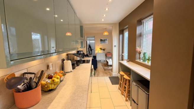 Modern Sage Kitchen and Cosy Living Space.png