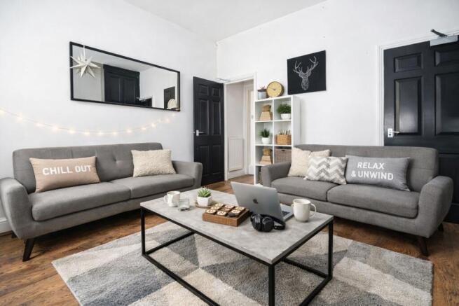 Stylish social space with modern grey sofas...