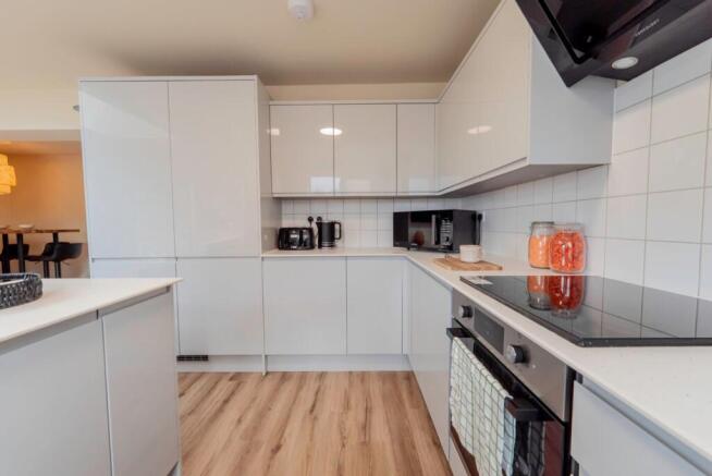 Bright modern kitchen with sleek white cabinets...