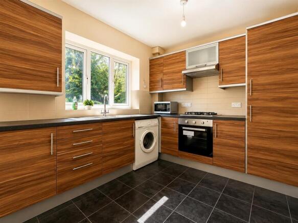 Modern kitchen with ample storage and appliance...