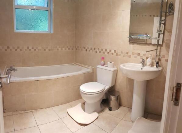 Bright, well-kept bathroom with a corner bathtu...