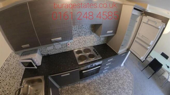 Bright modern kitchen with integrated appliance...