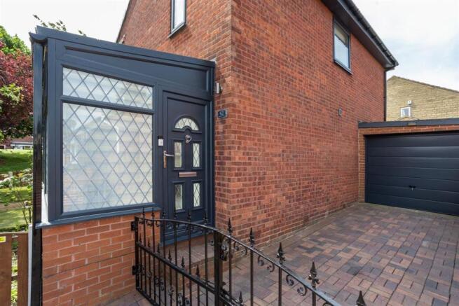 Rear entrance, driveway and garage