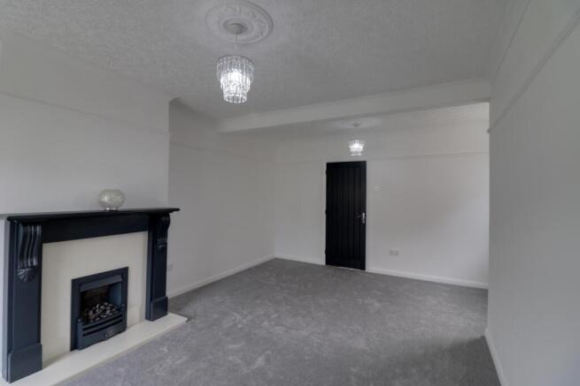 Lounge and dining area with a feature fireplace