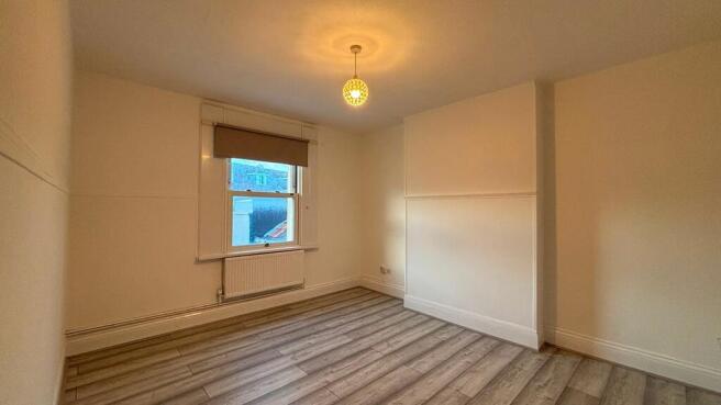 Bright, clean bedroom with modern wood flooring...