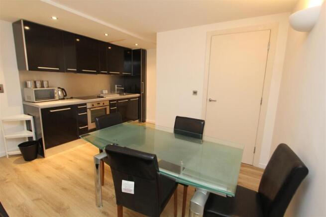 Modern kitchen with sleek units and dining area...